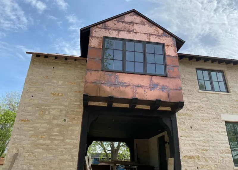 Copper metal panel facade on a stone building for Roof Repair in Floresville