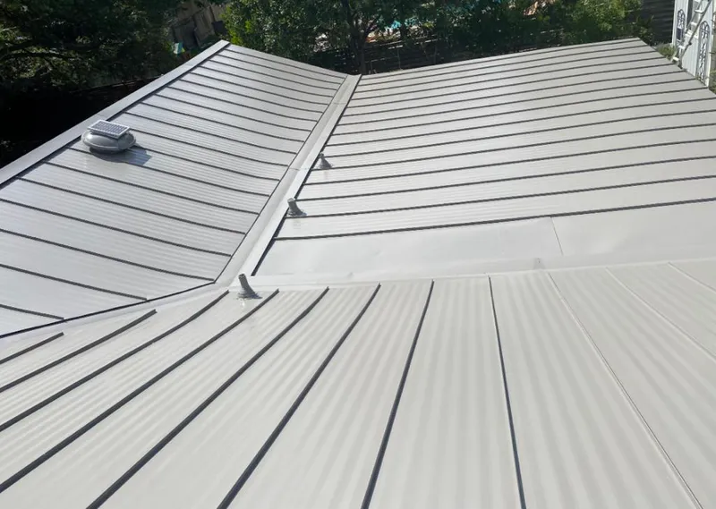 Solar attic fan installed on a metal roof for Roof Ventilation in Floresville