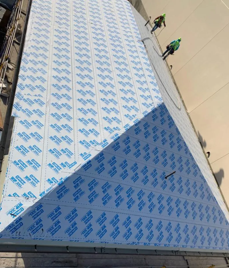 Professional roofers installing underlayment on a metal roof in Floresville